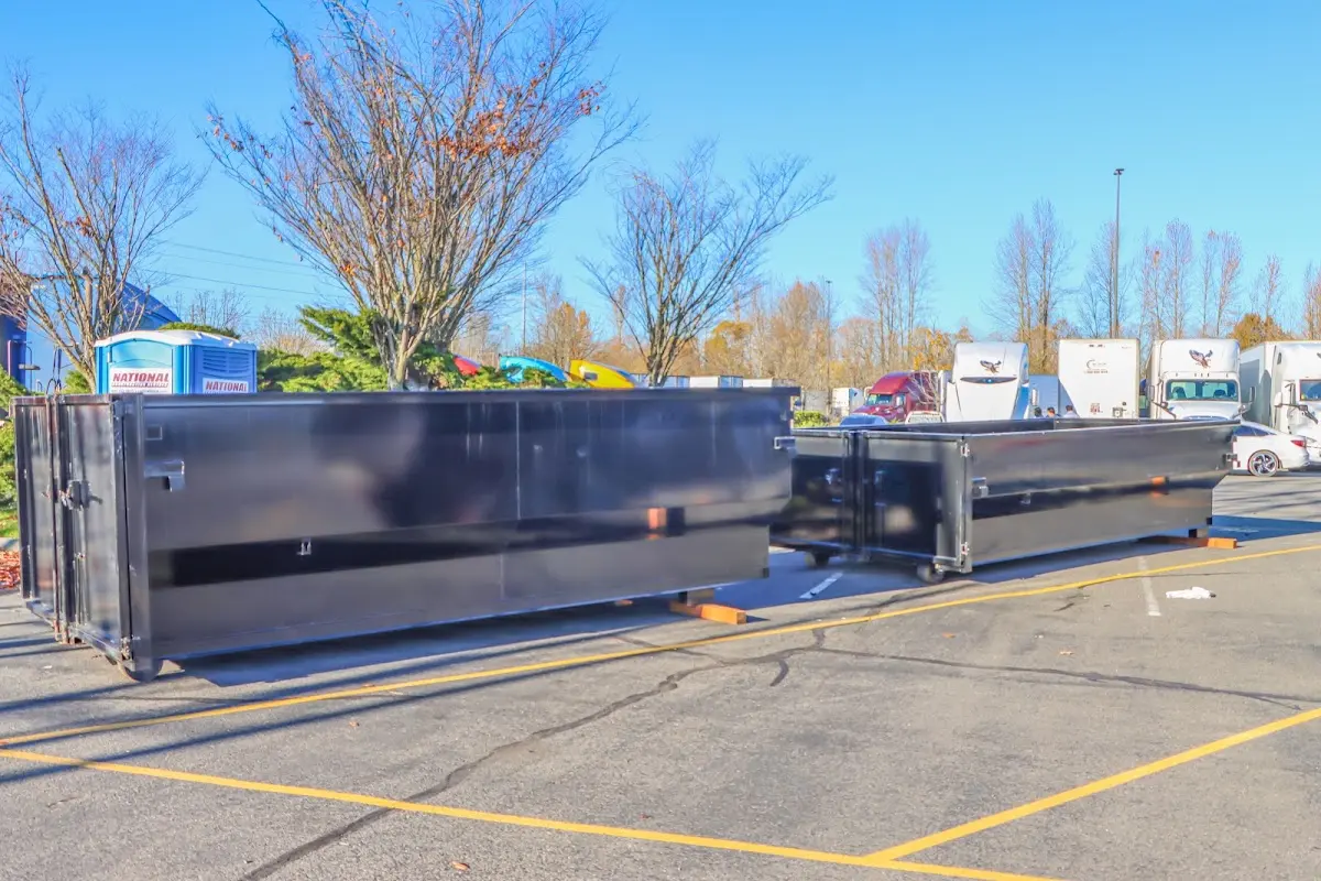 Professional dumpster rental service with roll-off container on residential driveway in South Apopka